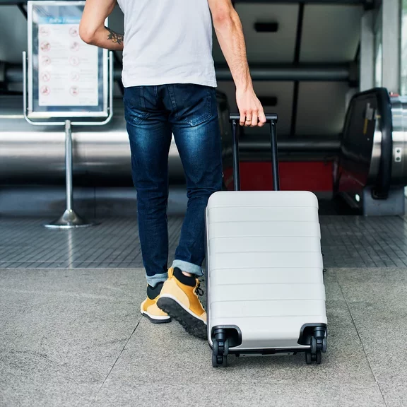 A man carrying a suitcase to travel